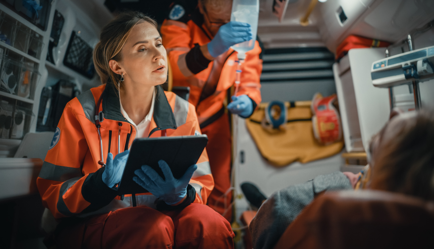 image of a girl checking vitals of a patient inside a non emergency patient transfer van